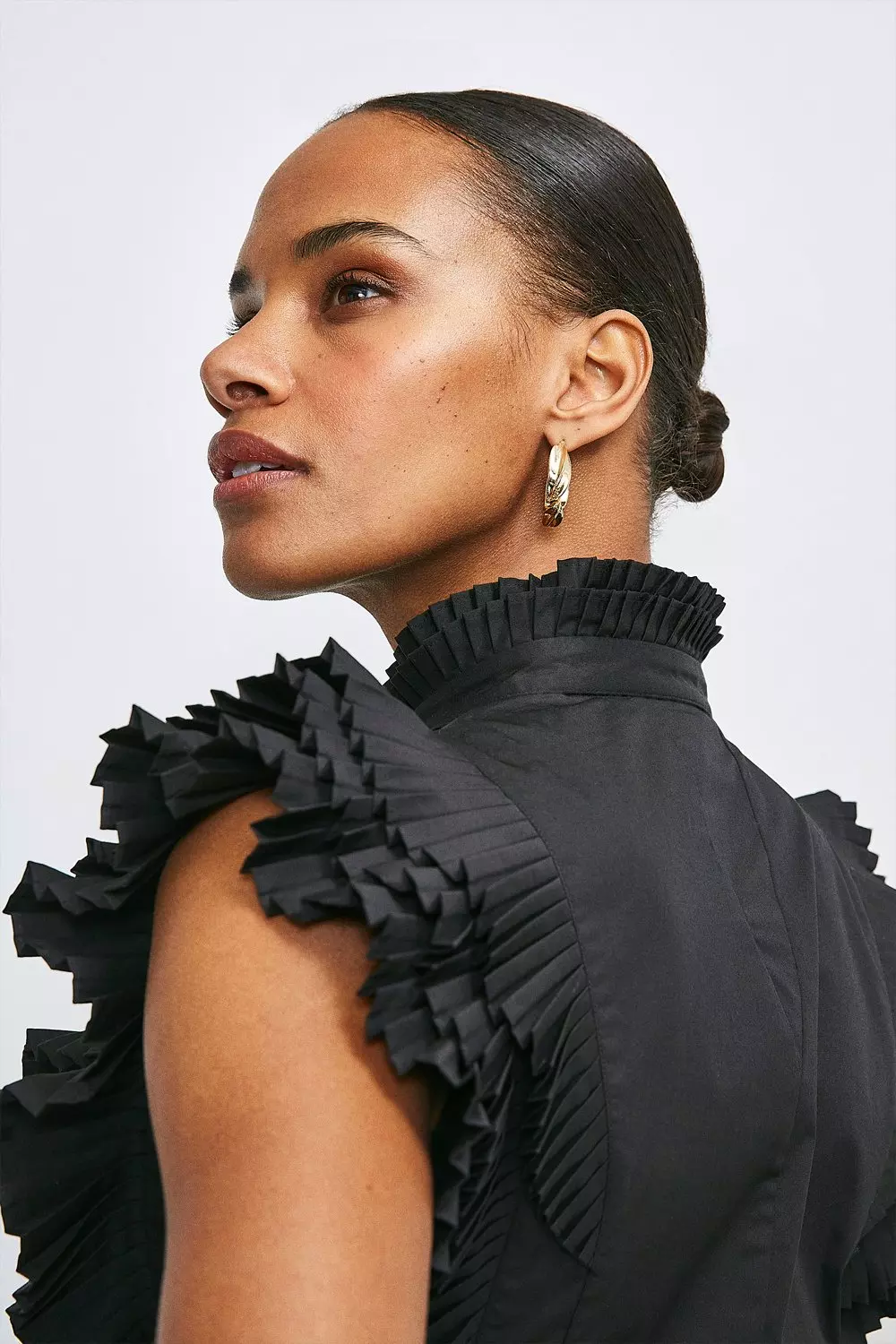 Black sleeveless ruffle blouse sales